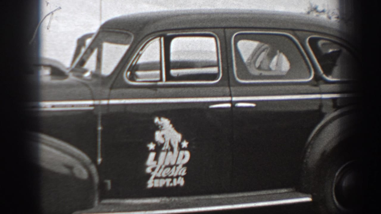 Side view of the same vintage sedan with a Lind Fiesta Sept. 14 door marking.