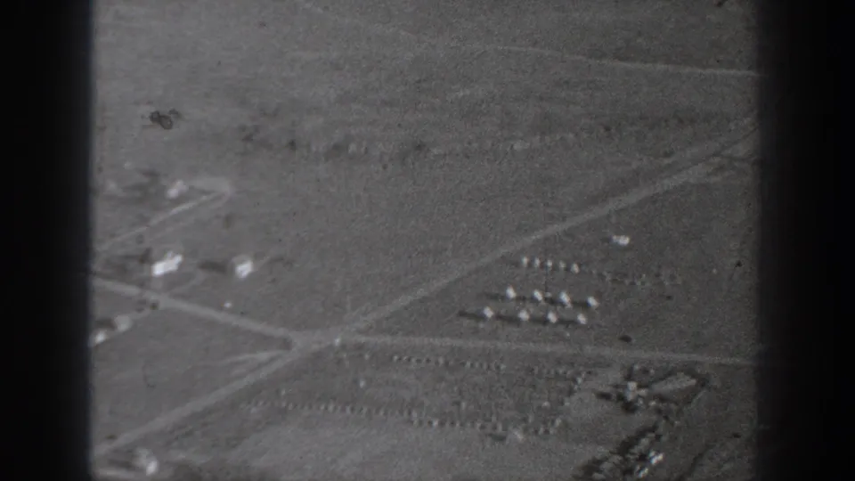 1940 Washington aerial view with intersecting roads, open fields, and small building groups in soft black-and-white film.