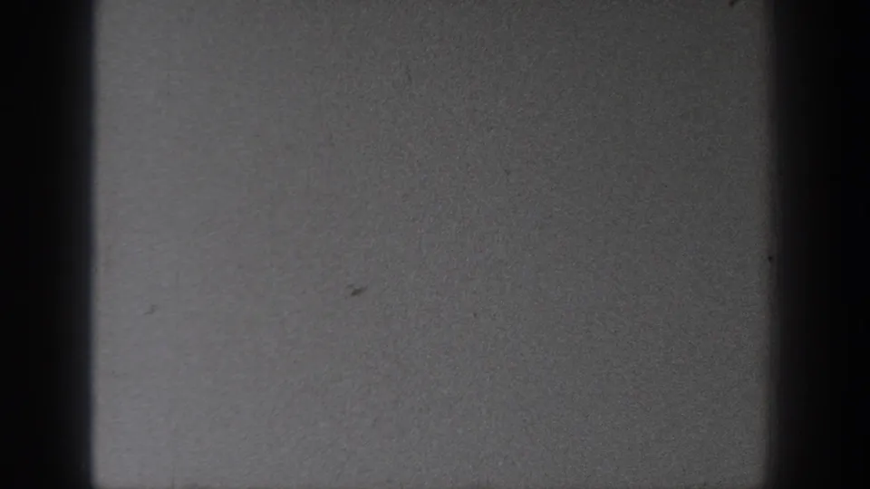 Washington 1940 home-movie frame with dark gate edges and a largely blank, softly exposed field of sky or film leader.