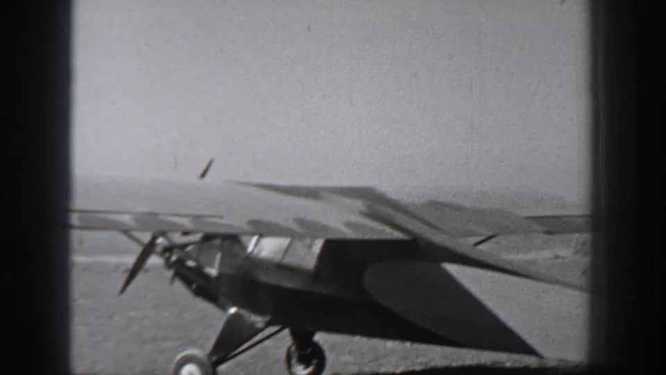 Small propeller aircraft on an open Washington airfield in 1940-era black-and-white home-movie footage.