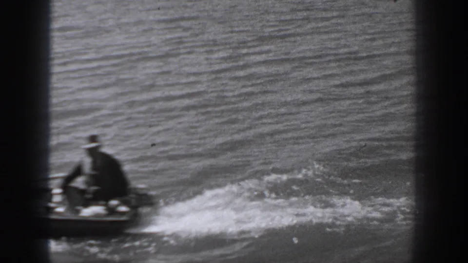 Near the end of the Washington river shot, the motorboat moves partly out of frame while wake spreads across the water.