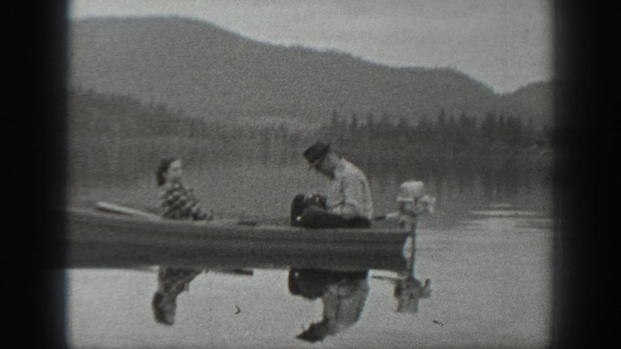 A man looks down near the motor while a woman sits beside him in a small boat.