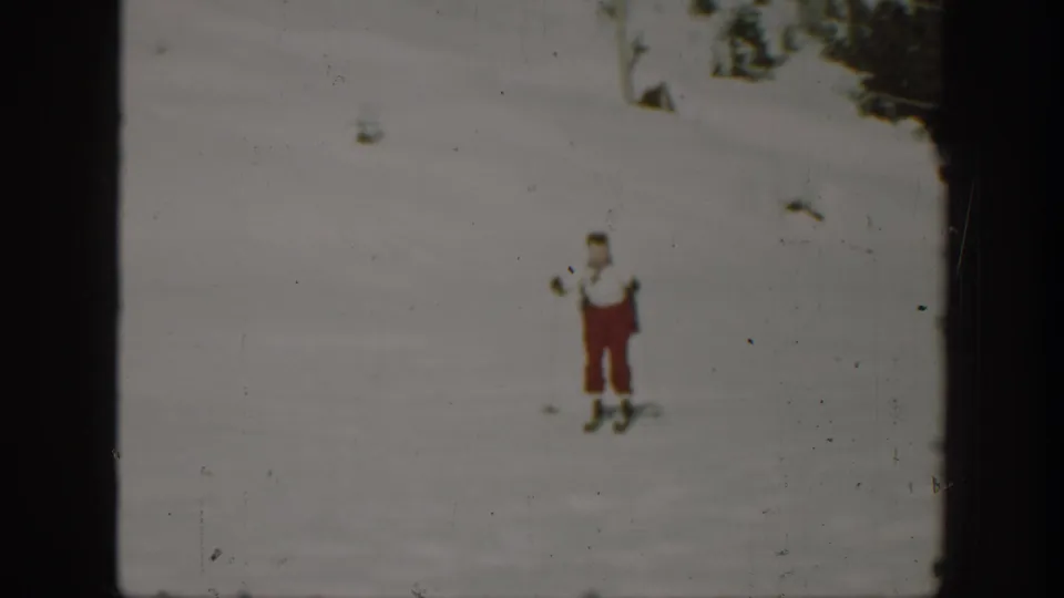 1940 Washington 8mm frame showing an adult skier facing the camera with poles on a snowy slope.