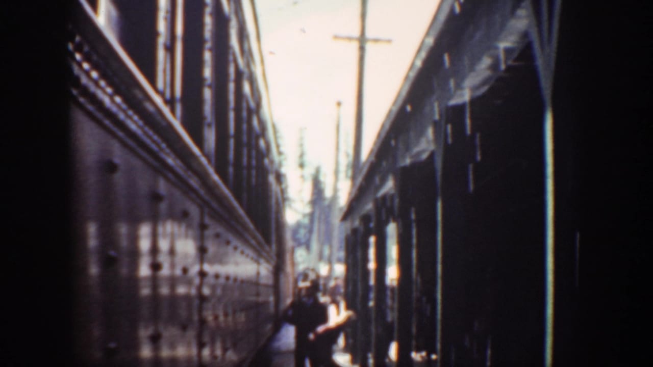 Similar narrow passage view with a person closer to the center-right opening.