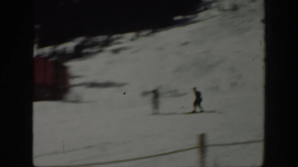 Washington 1940 ski scene with one skier descending across the snow and a red structure behind the slope.