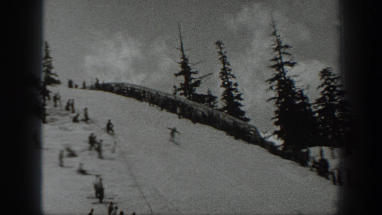 1940 Washington ski scene with onlookers along a ridge and skiers descending below tall evergreens.