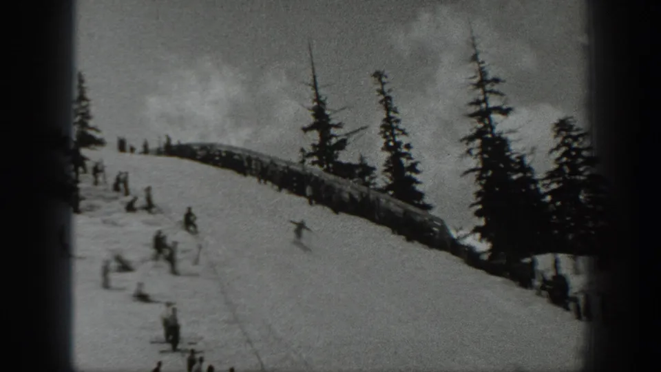 1940 Washington ski scene with onlookers along a ridge and skiers descending below tall evergreens.