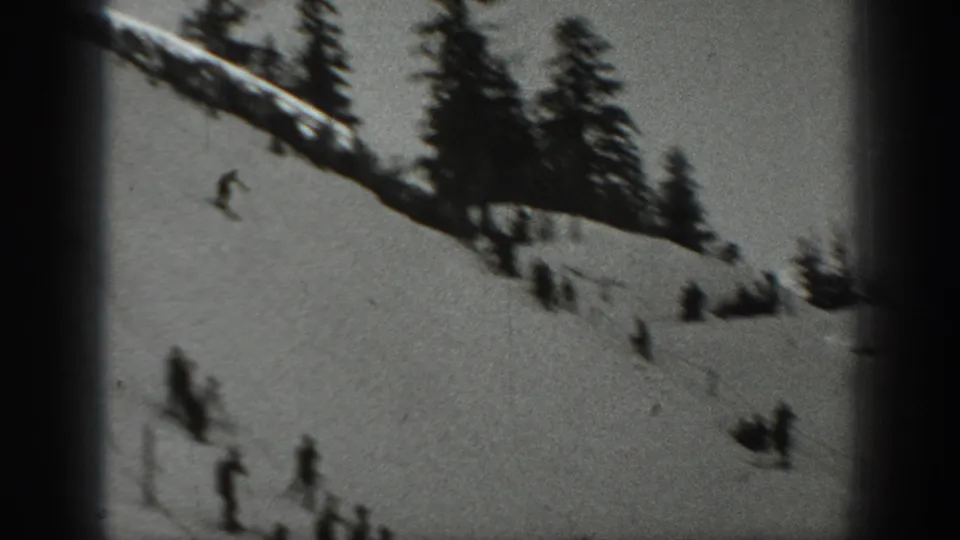 1940 Washington ski scene with small figures descending a broad snowfield below a line of evergreens.