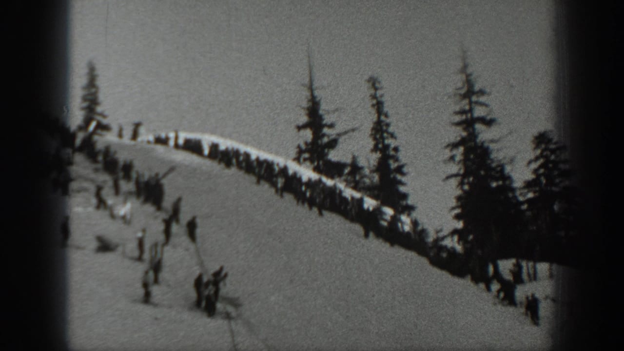 1940 Washington ski footage shows small figures on a snowy ridge with pine trees along the slope.