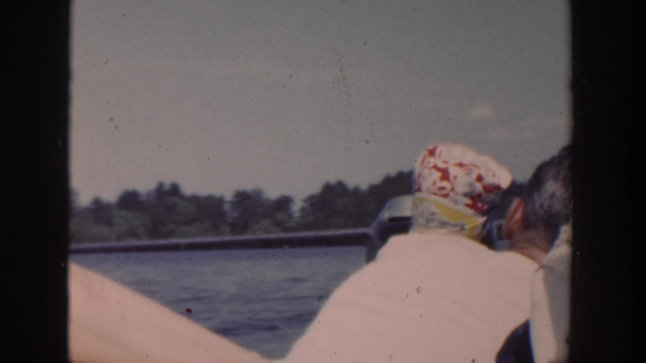 1953 Wisconsin home-movie frame from a boat, with an adult and baby seen from behind near the rail.