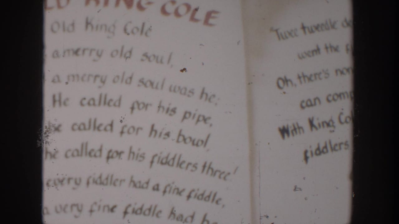 Close view of Old King Cole rhyme text with adjacent partial verse text.