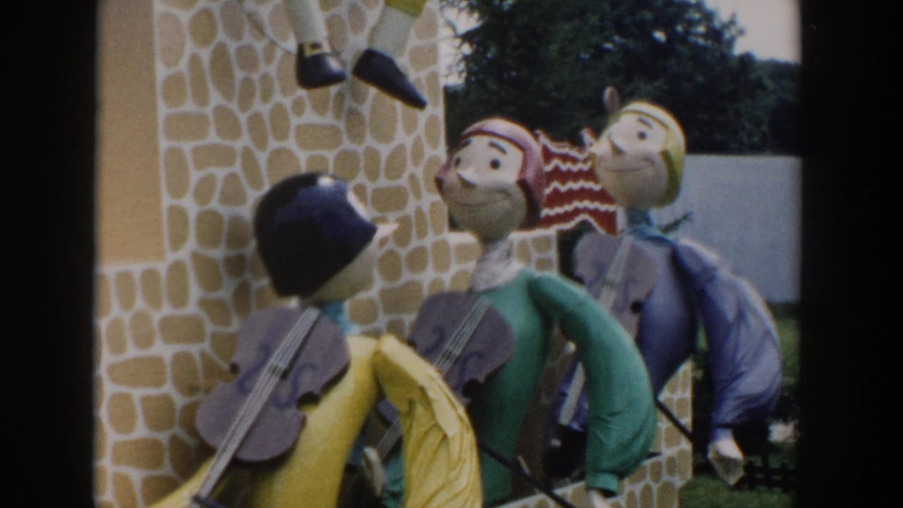 Costumed puppet-like figures stand near a stone-textured facade.