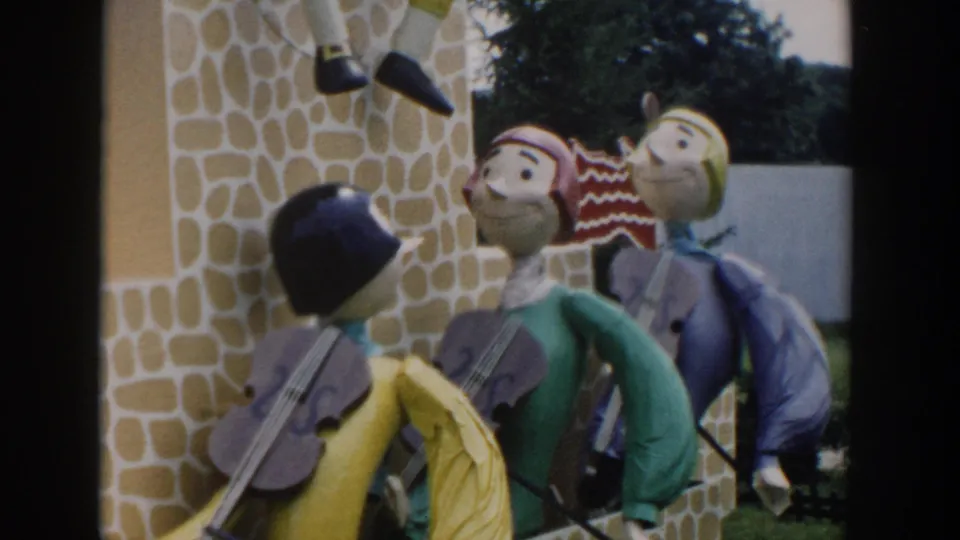 Color 8mm frame from Wisconsin Dells showing handmade character figures against a playful stone-patterned wall.