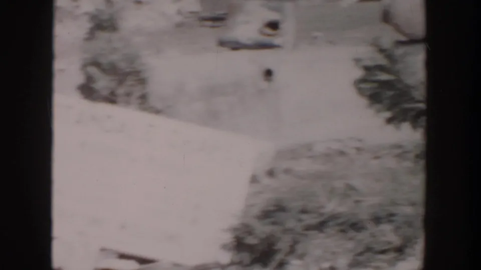Soft 8mm frame in Grand Rapids showing the chapel sign partly out of frame with debris and vegetation around it.