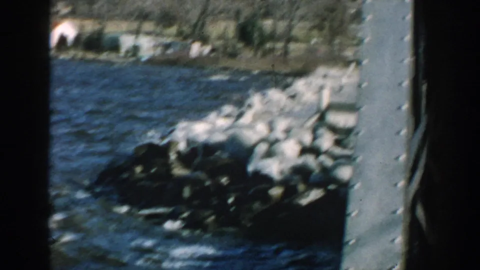 Soft 8mm frame of rough water and white spray striking a rock jetty on a Wisconsin shoreline.