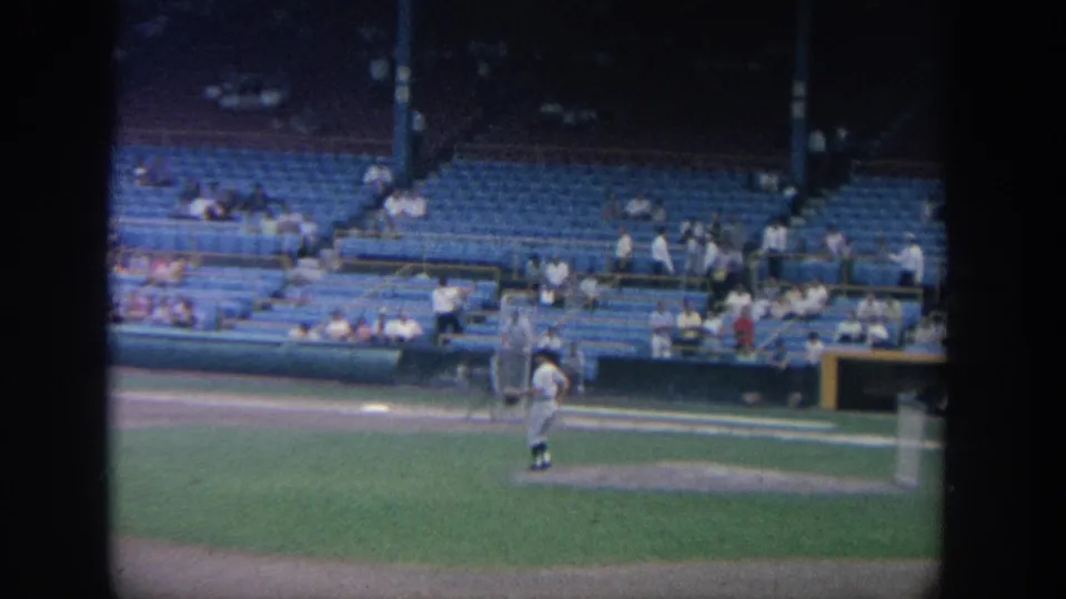1964 New York 8mm view of a pitcher standing on the mound before a sparse stadium crowd.
