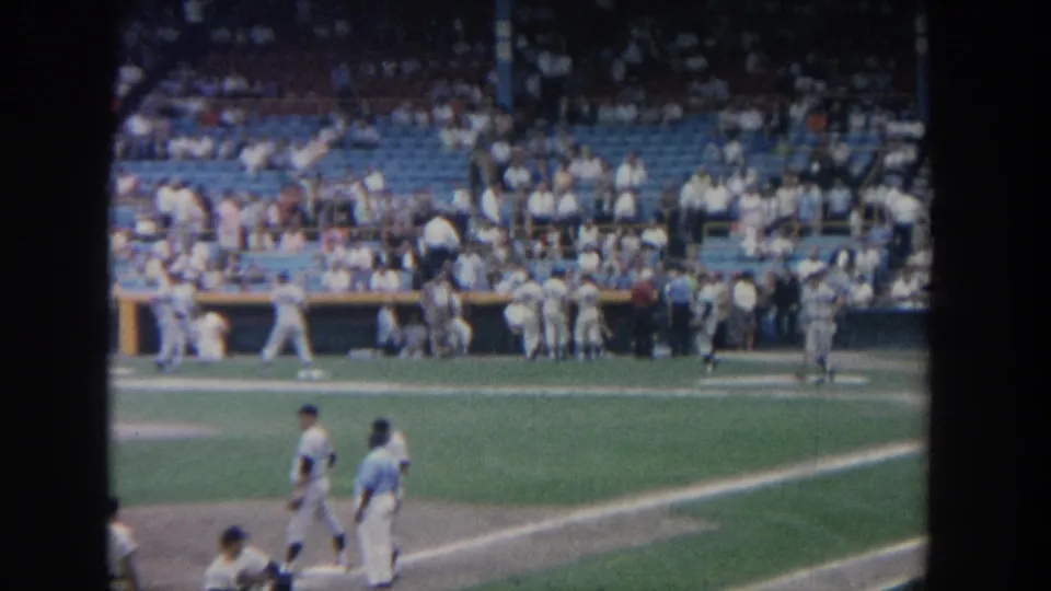 New York 1964 baseball stadium scene with players near the baseline, dugout figures, and spectators in blue seats.