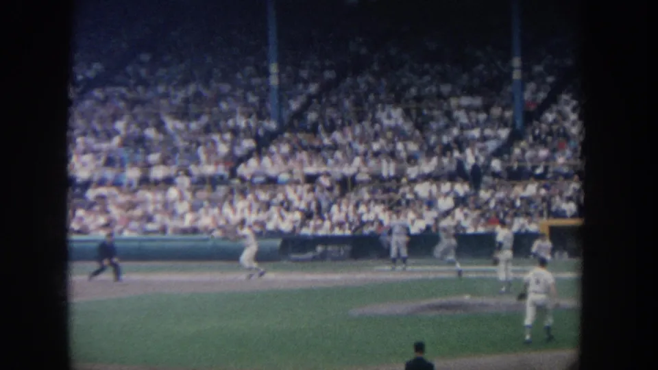 Wide 1964 New York baseball stadium view with players spread across the field and spectators filling the grandstand.