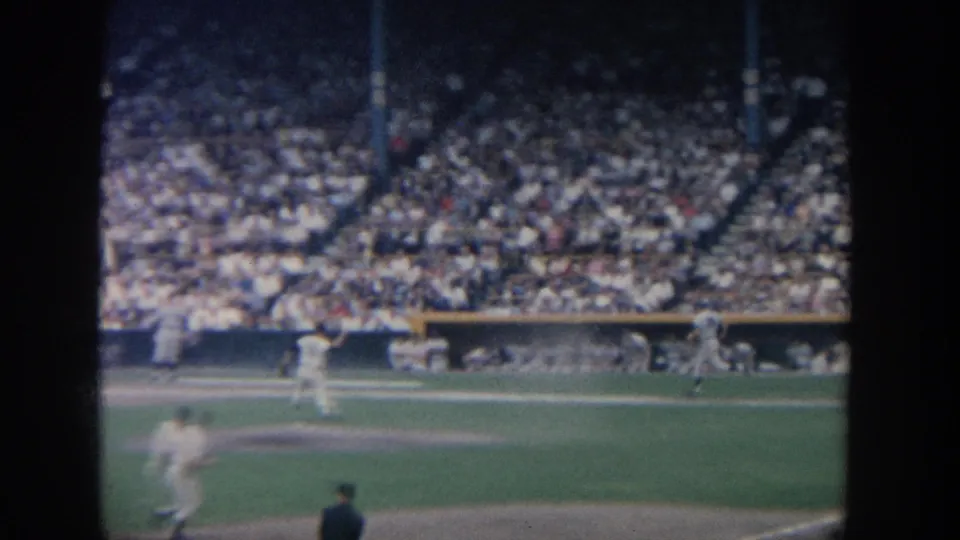 1964 New York 8mm view of baseball players on the field before a densely filled stadium crowd.