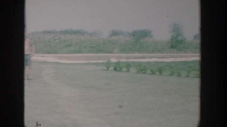 The final frame shows a pale yard, path, and distant field edge, with only a partial figure at the left edge.