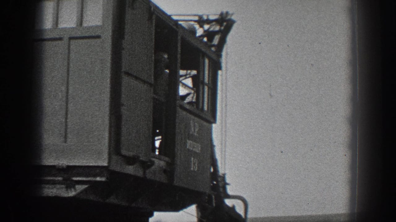 1936 California 8mm frame showing the side of a marked ditcher crane cab with an operator silhouette inside.