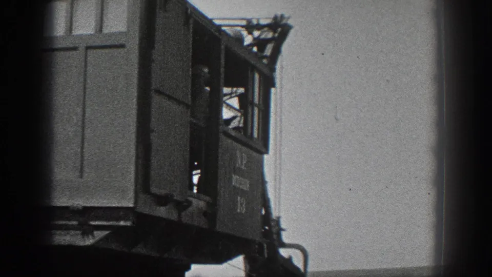 1936 California 8mm frame showing the side of a marked ditcher crane cab with an operator silhouette inside.