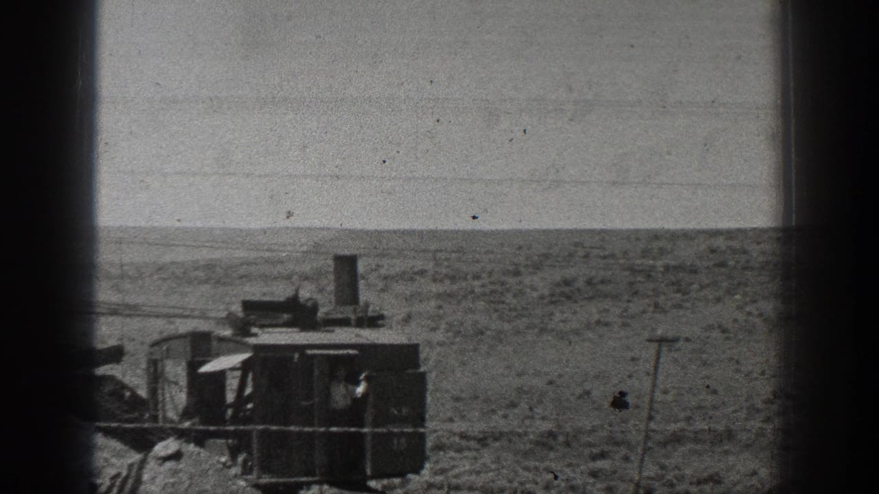 The steam-powered machine appears farther across the California desert, with the worker partly visible inside the dark cab.