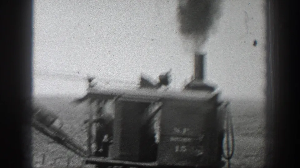 1936 California frame showing the rail-mounted steam excavator cab, smoke stack, boom, and partial lettering on the machine body.