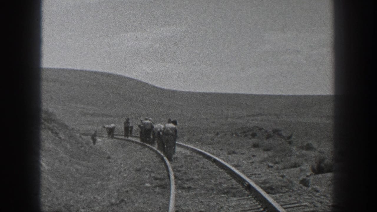 Men in work clothes appear on a curved rail line in 1936 California, filmed from a distance on black-and-white 8mm.