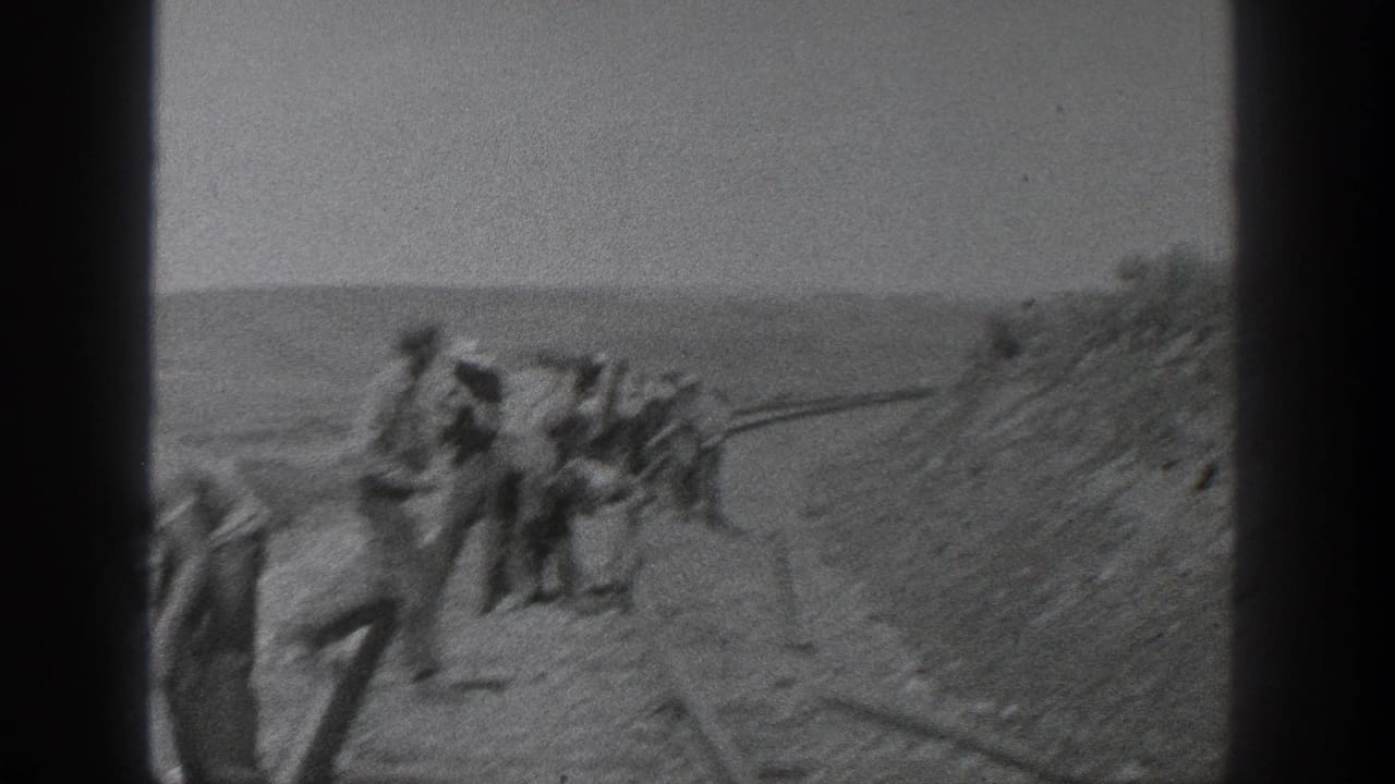 In 1936 California footage, several workers appear beside railroad tracks in a broad rural landscape, seen through a grainy 8mm frame.