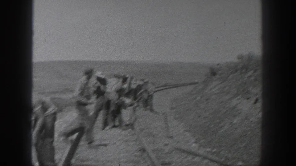 In 1936 California footage, several workers appear beside railroad tracks in a broad rural landscape, seen through a grainy 8mm frame.