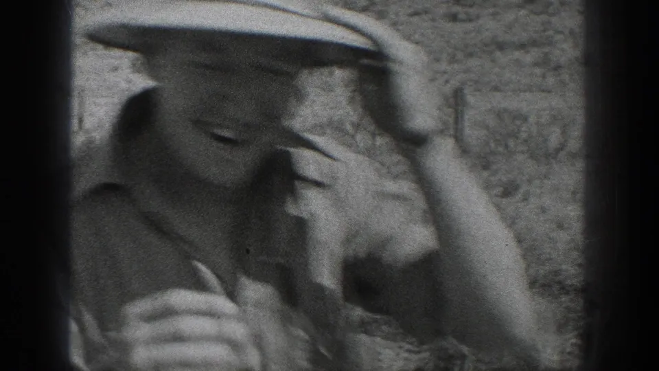 Soft-focus California 1936 home-movie close-up of a worker in a brimmed hat, partially cropped by the 8mm frame.