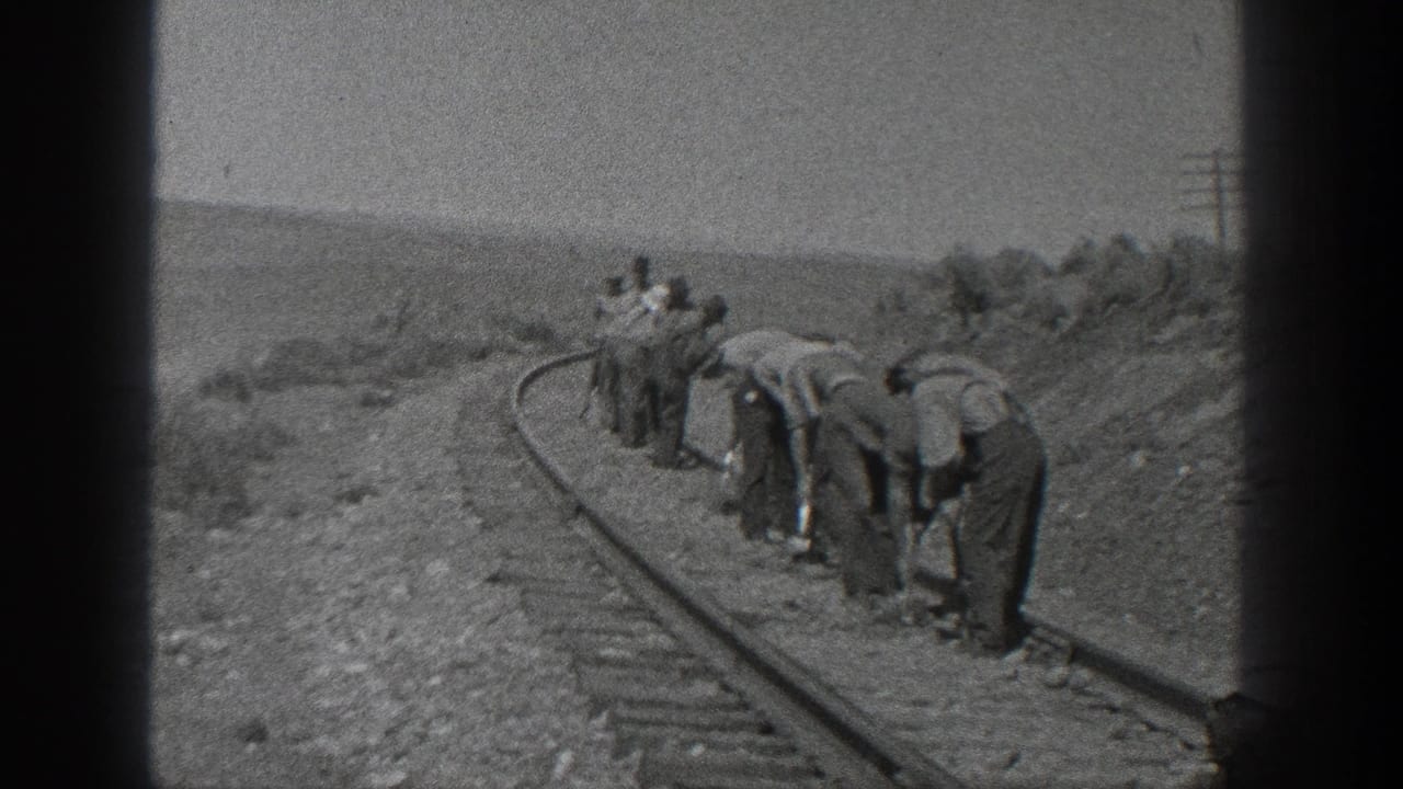 In 1936 California home-movie footage, a group of workers appears to clear or inspect a curved railroad track by hand.