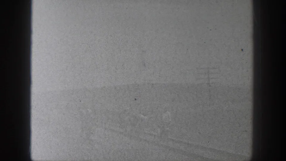 1936 California 8mm frame appears largely overexposed or leader-like, with dark gate edges and small dust marks visible.