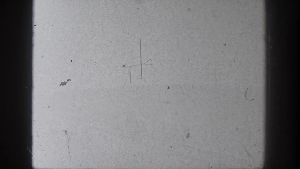 A pale 8mm frame from the 1936 California clip shows film borders, dust, and faint marks rather than clear landscape detail.