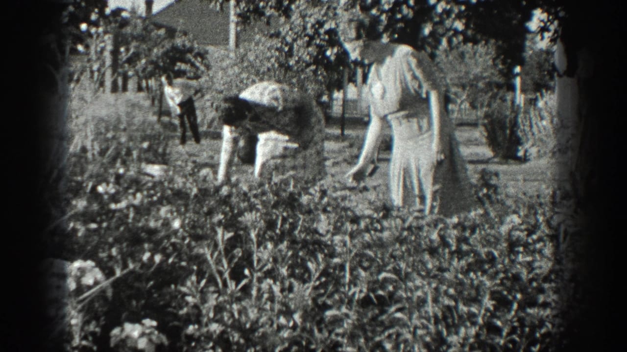 Black-and-white 8mm frame from 1936 California showing one woman bending over a garden bed as another woman watches nearby.