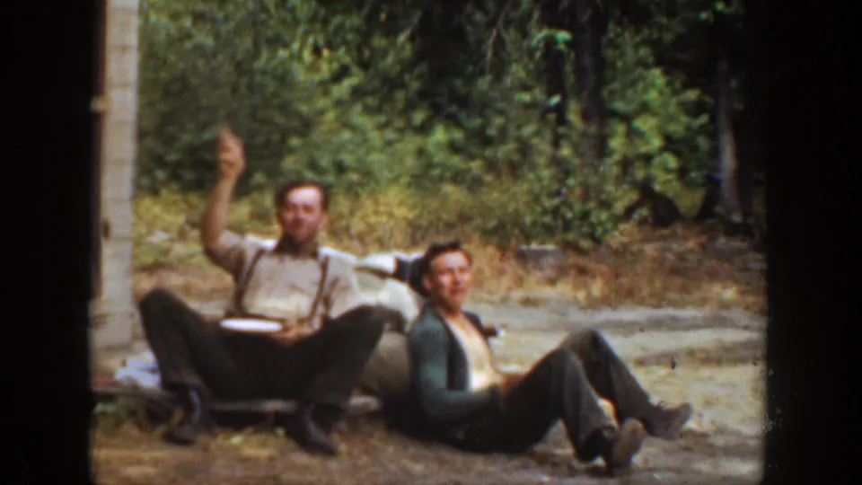 At the end of the 1936 California clip, one man raises his arm toward the camera while his companion sits back on the ground.