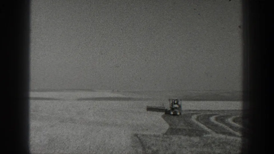 A distant horse-drawn farm implement works across a California field, leaving visible furrows in 1936 black-and-white 8mm footage.