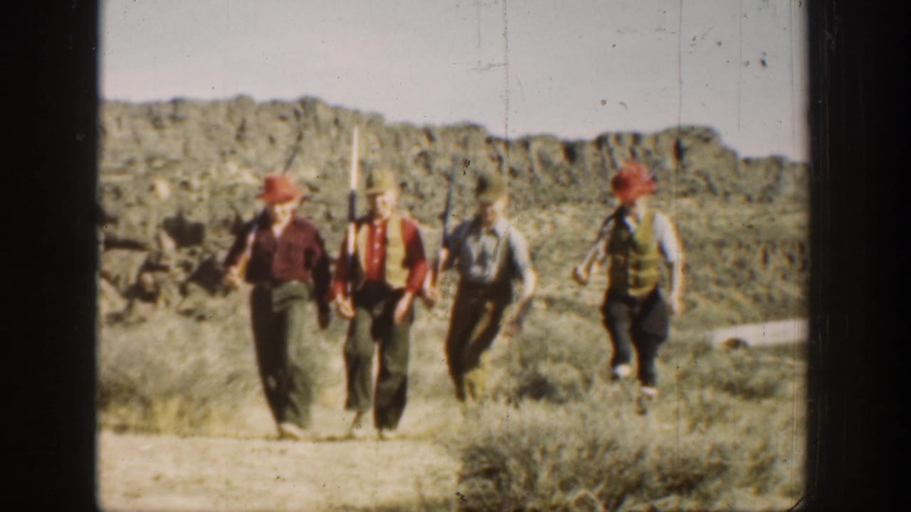 In metadata-supported 1936 California footage, four young men in hats and vests march across a desert landscape while carrying long rifles.