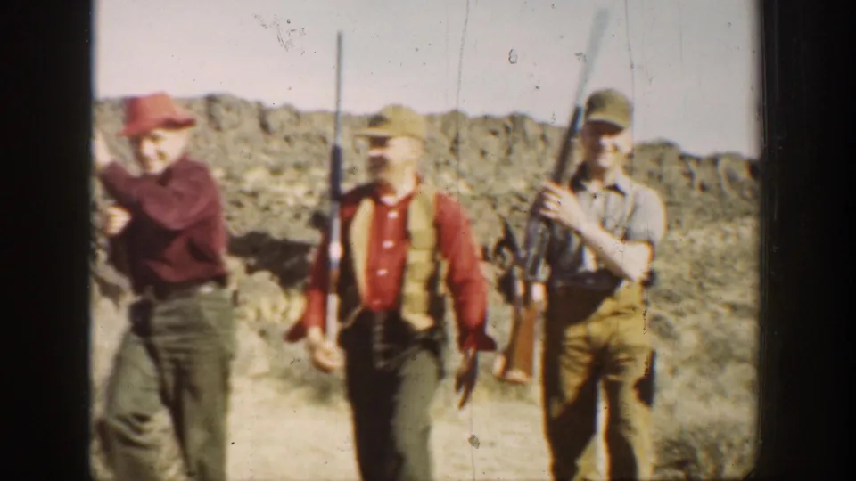 A closer 1936 California frame shows three young men with rifles, hats, and vests against a sunlit desert ridge.