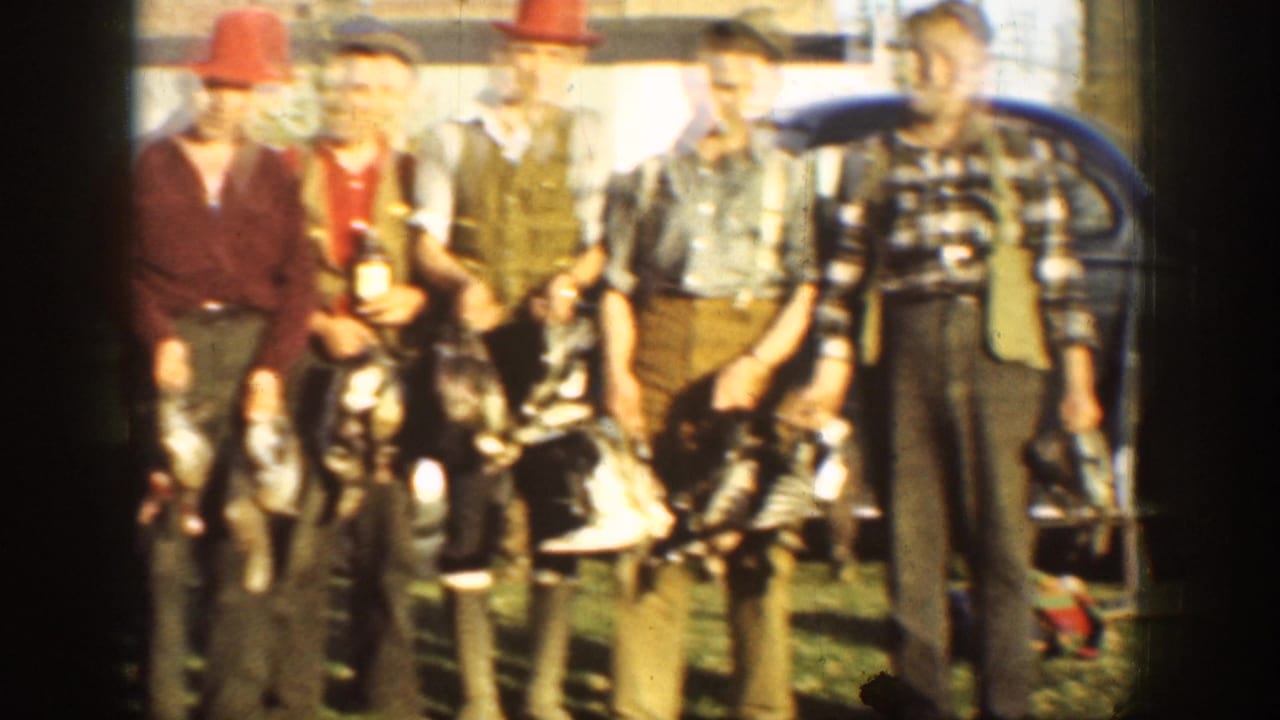 Five adult men in period hunting clothes stand outdoors in California with dead game birds and a dark car behind them.