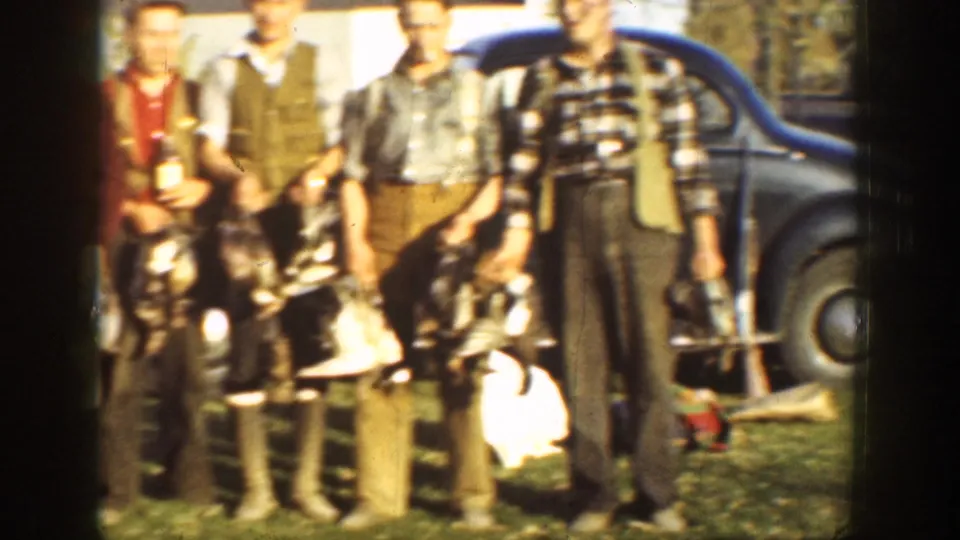 A closer 1936 California frame shows several hunters holding game birds, with boots, suspenders, and part of a dark car visible.