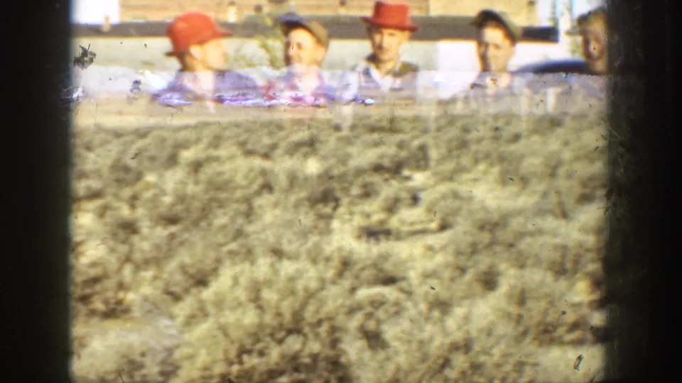 The final frame shifts to rough open ground, with the hunters and car partly visible in the background of the California home movie.