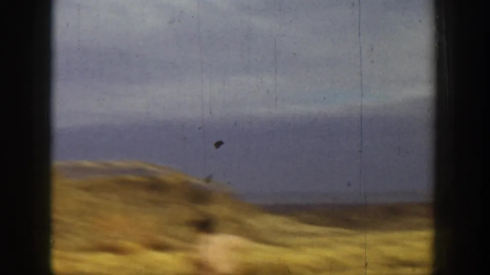 Wide 8mm view of dry California hills and cloudy sky, likely a transitional shot within the 1936 home movie.