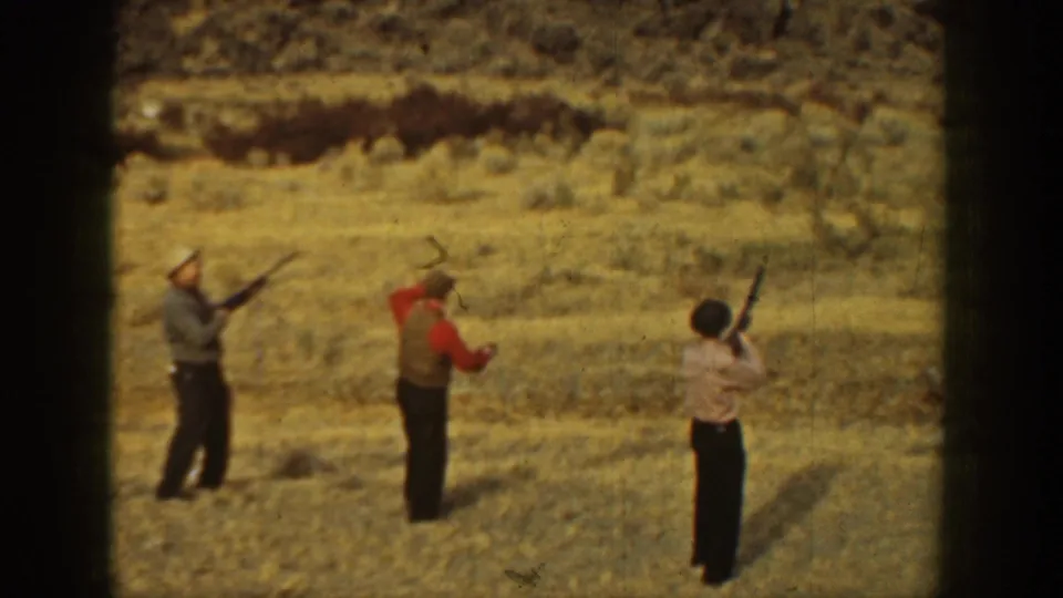 A closer 1936 California frame shows three men in hats and shirts aiming or holding shotguns during field practice.