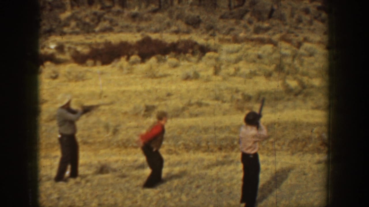 1936 California 8mm frame showing men in an open dry field during informal target shooting practice.