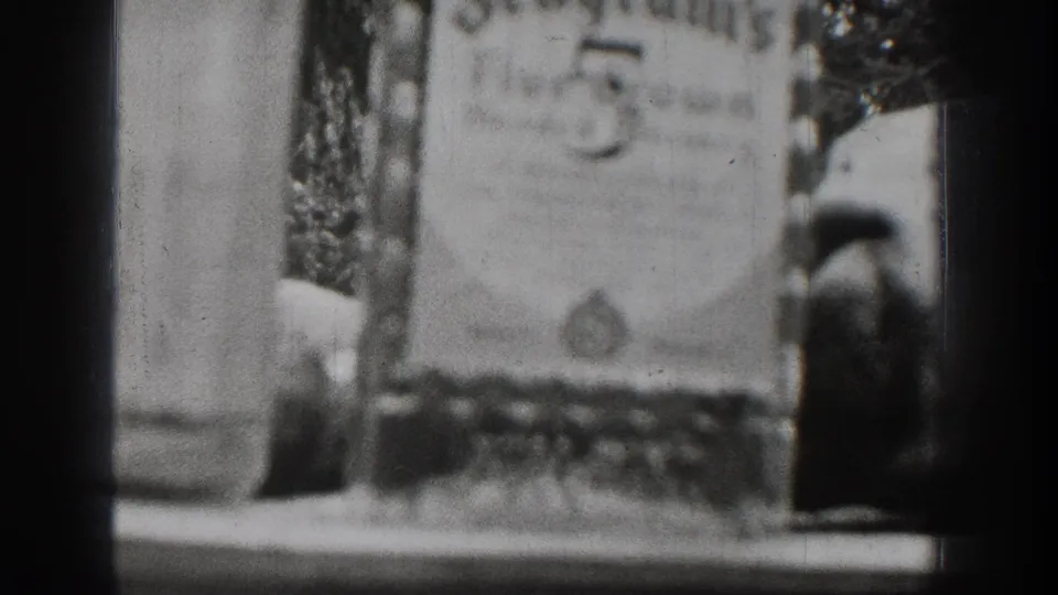 1939 Chelan home-movie frame with a soft, partially obscured close-up near a tabletop and dark 8mm frame edges.