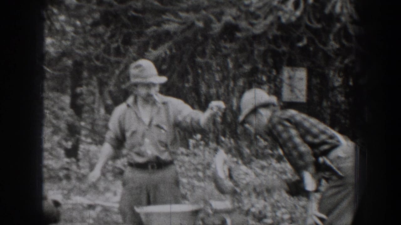 In 1939 Chelan, Washington home-movie footage, two adult men appear to handle equipment near a metal basin among trees.