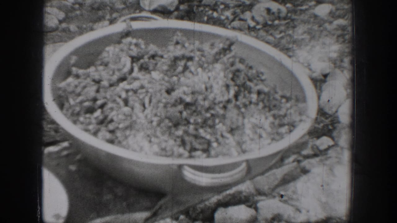 A large bowl of processed ground meat sits outside in the 1939 Chelan, Washington home-movie scene.