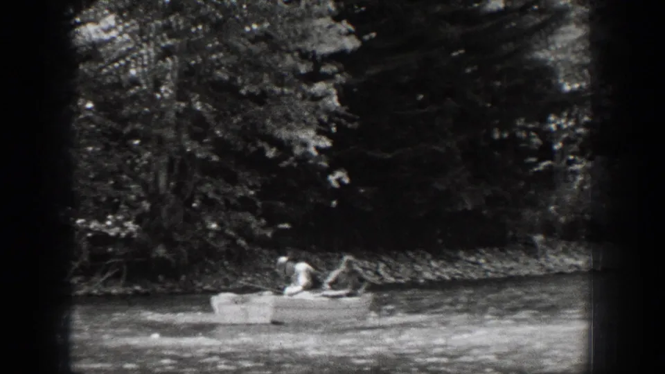 The rowboat appears farther from camera near a tree-lined bank, with two men visible aboard in the Chelan footage.